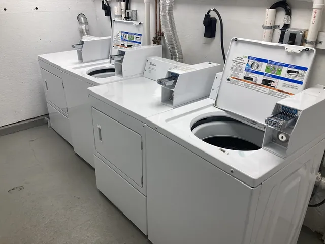 a kitchen with a sink and a stove with white countertops