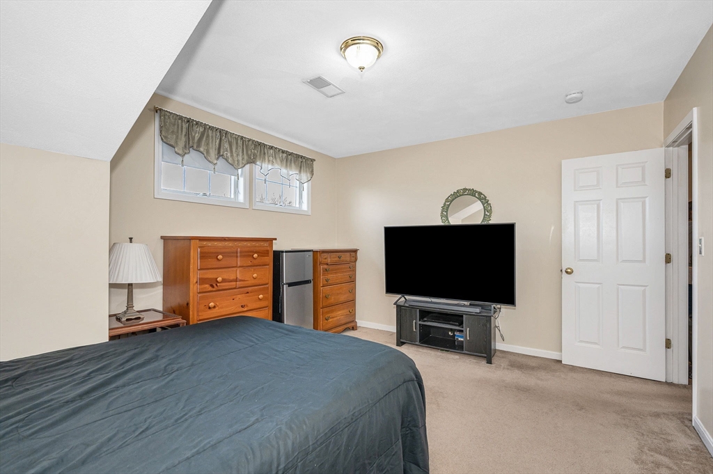 39 Broadway, Unit 305 Malden, MA 02148 - Photo 25 of 36 a living room with furniture and a flat screen tv