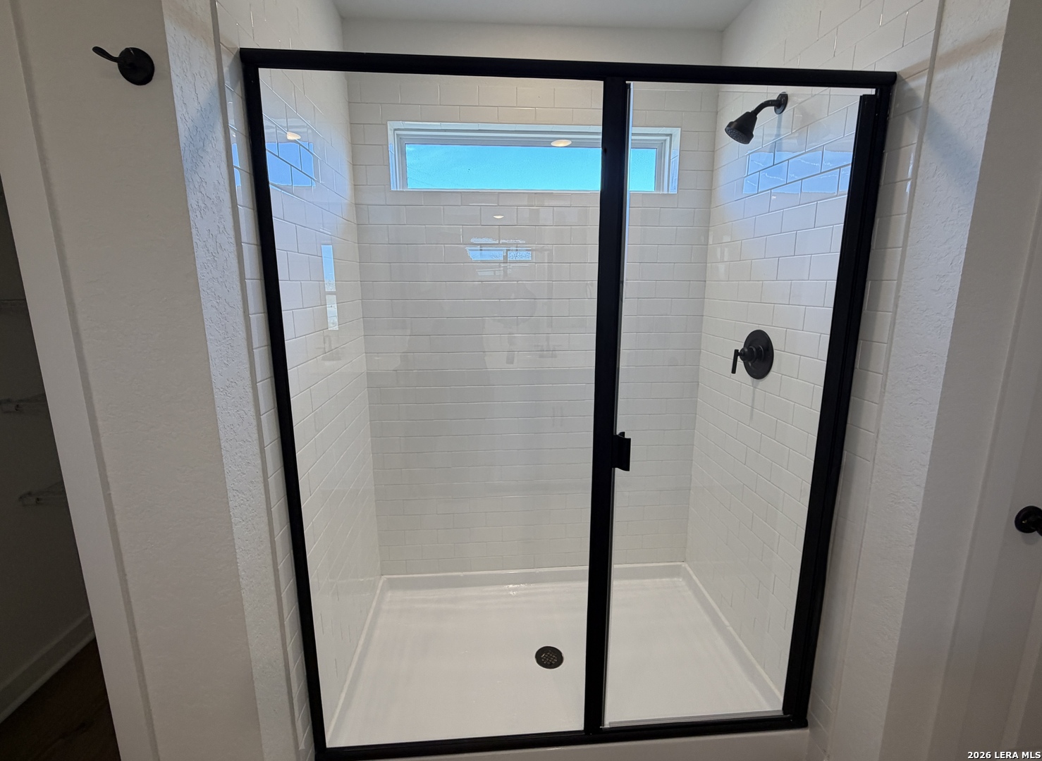 410 Nottabi Road Adkins, TX 78101 - Photo 19 of 33 a bathroom with a glass shower door and a sink