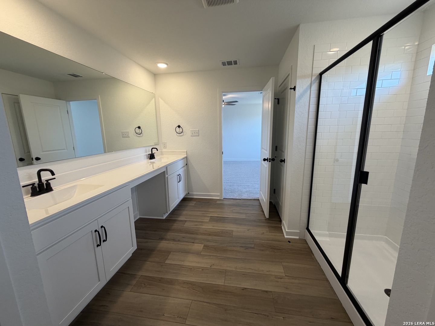 410 Nottabi Road Adkins, TX 78101 - Photo 20 of 33 a spacious bathroom with a double vanity sink and a mirror