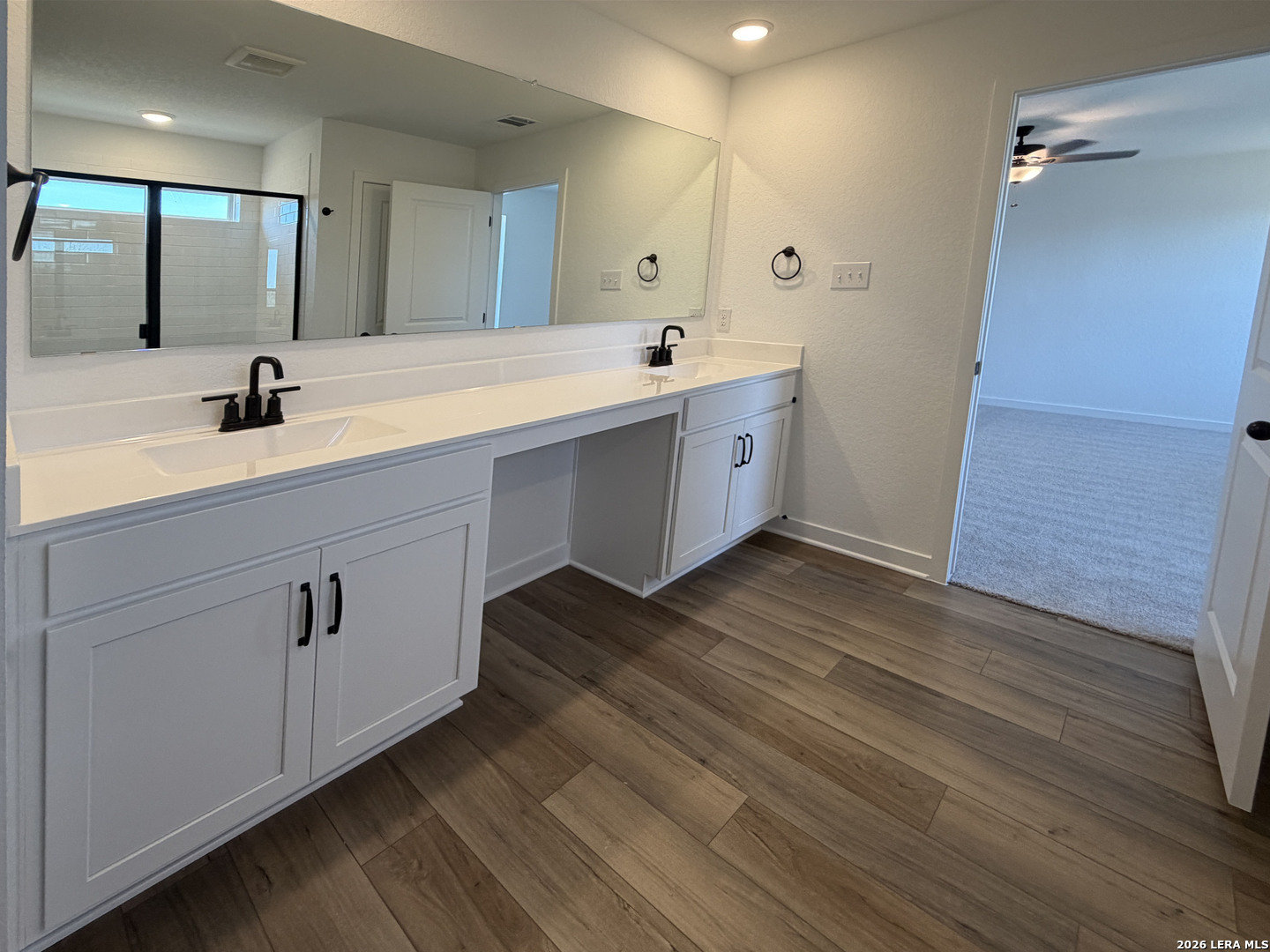 410 Nottabi Road Adkins, TX 78101 - Photo 21 of 33 a bathroom with double vanity sink and mirror