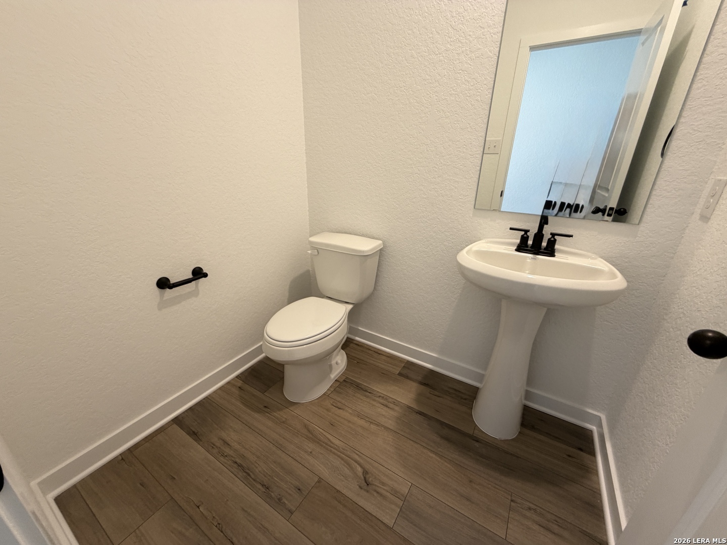 410 Nottabi Road Adkins, TX 78101 - Photo 32 of 33 a bathroom with a sink toilet and a mirror