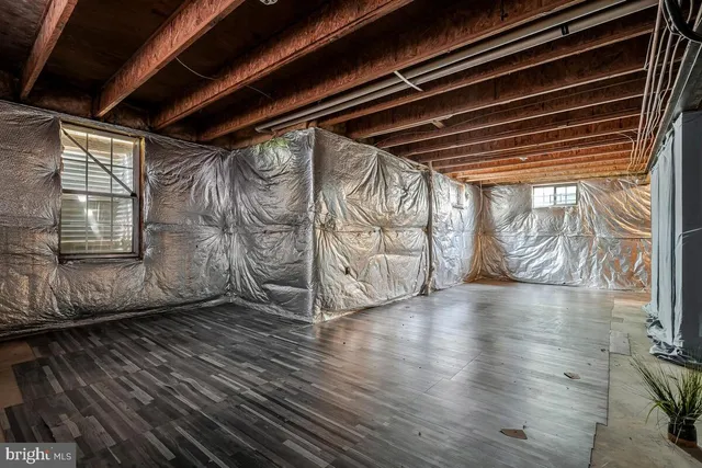 a utility room with a wooden floor washer and dryer