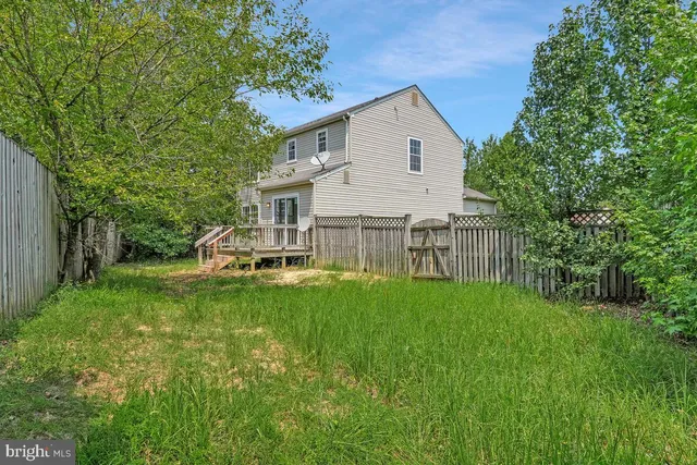 a backyard of a house with barbeque oven and outdoor seating