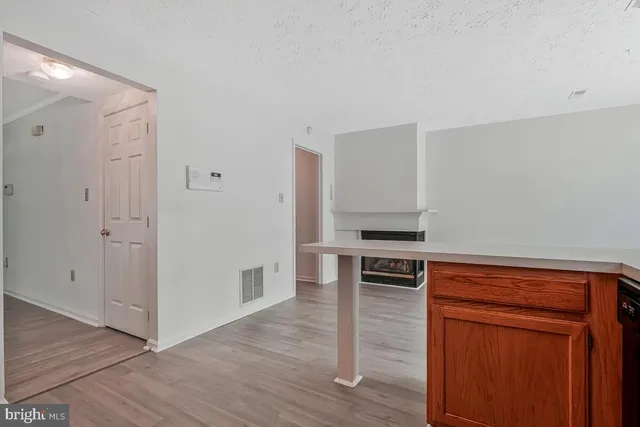 a kitchen with wooden floors and white appliances