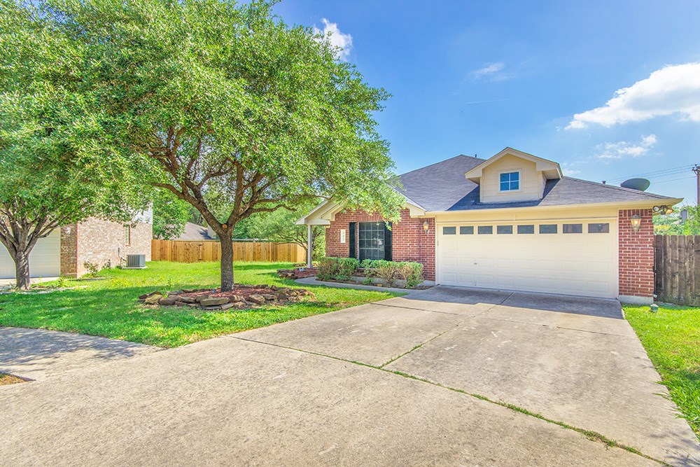 502 Hyde Cove Leander, TX 78641 - Photo 1 of 1 a front view of a house with a yard and garage