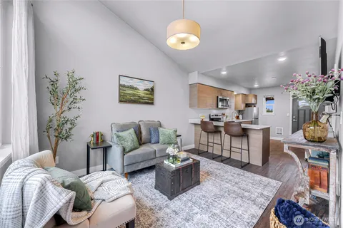 a living room with furniture and a chandelier