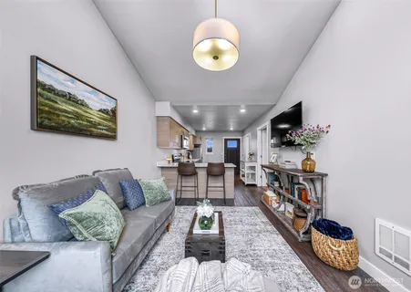 a living room with furniture and a chandelier