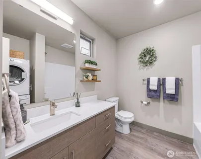 a bathroom with a sink a toilet and mirror