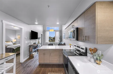 a kitchen with stainless steel appliances microwave stove refrigerator sink and cabinets