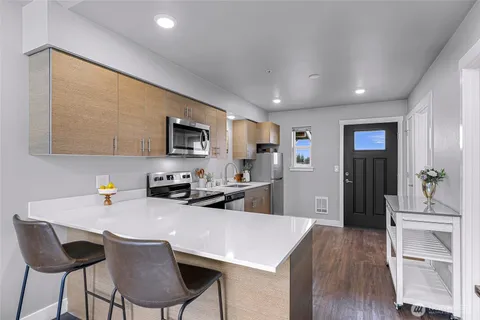 a kitchen with white cabinets and stainless steel appliances
