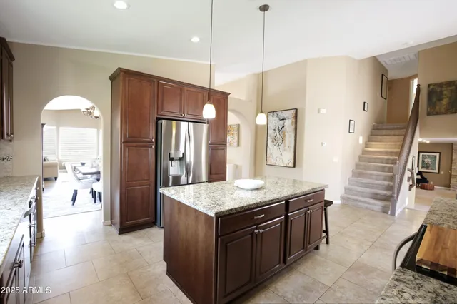 a dining room with furniture a chandelier and wooden floor