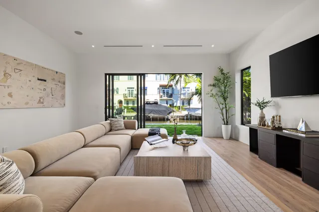 a bedroom with a large bed and a flat screen tv