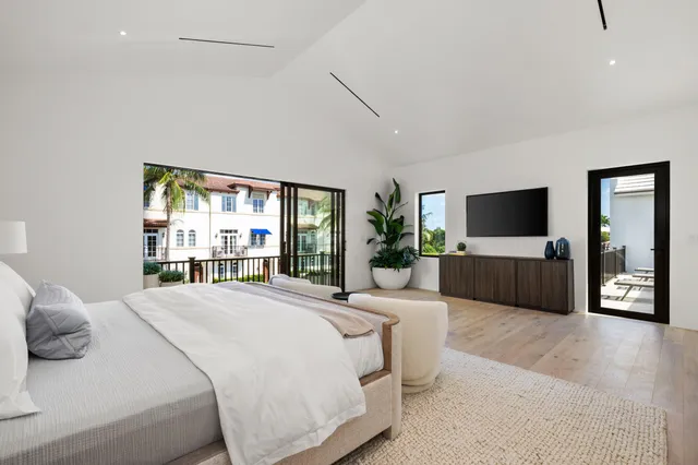 a large bathroom with a tub sink and mirror