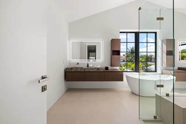 a bathroom with a tub sink and mirror