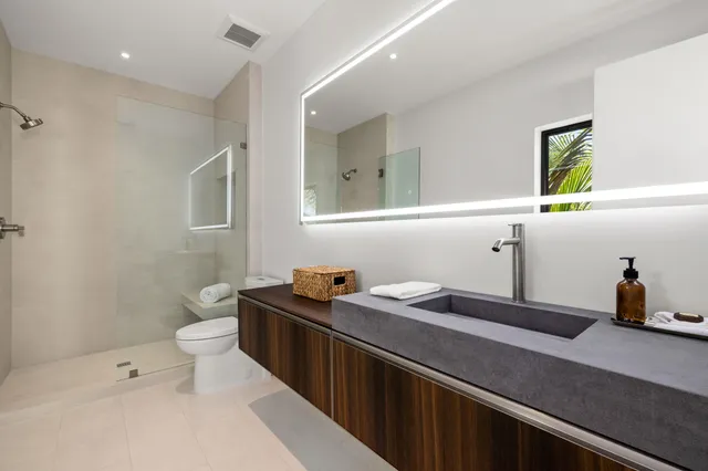 a living room with furniture a window and a flat screen tv