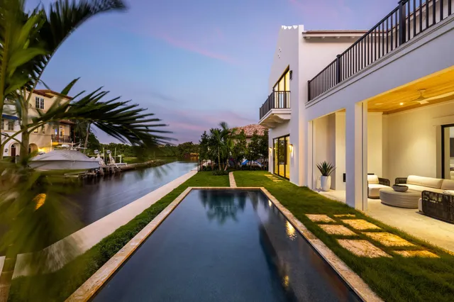a view of a house with backyard and a patio