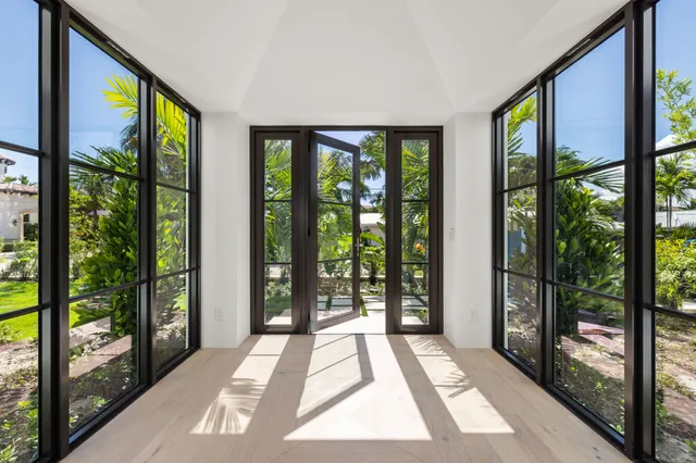 a living room with furniture wooden floor and a large window