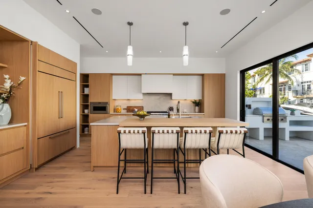 a view of a hallway with wooden floor and a living room
