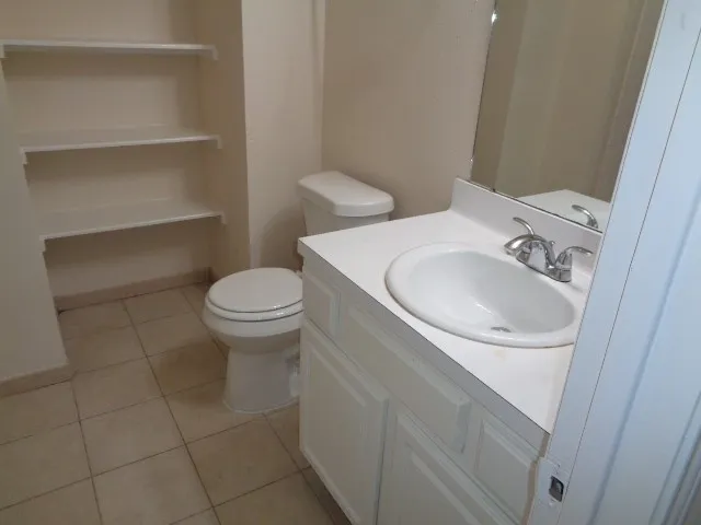 a bathroom with a sink toilet and a mirror