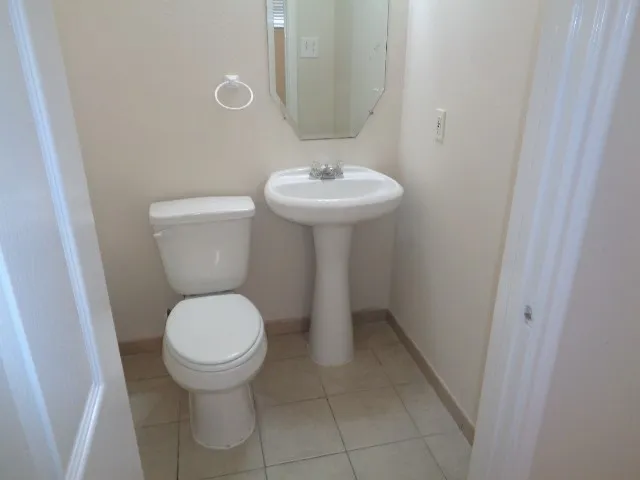 a bathroom with a sink toilet and a mirror