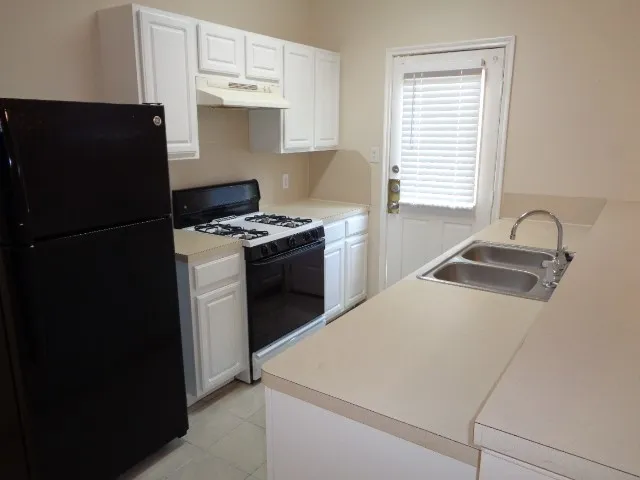 a kitchen with a refrigerator stove and sink