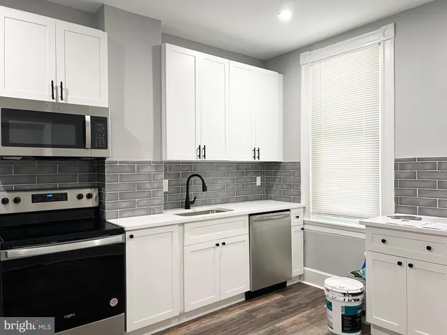 a kitchen with a sink stove and microwave