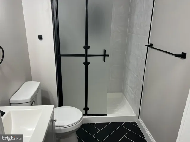 a bathroom with a toilet and a shower