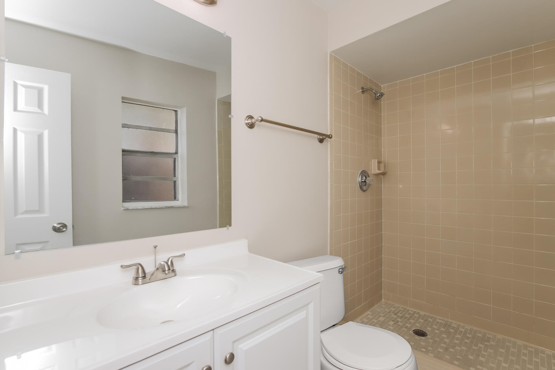 3386 Jay Tee Drive Melbourne, FL 32901 - Photo 10 of 16 a bathroom with a sink toilet vanity and shower
