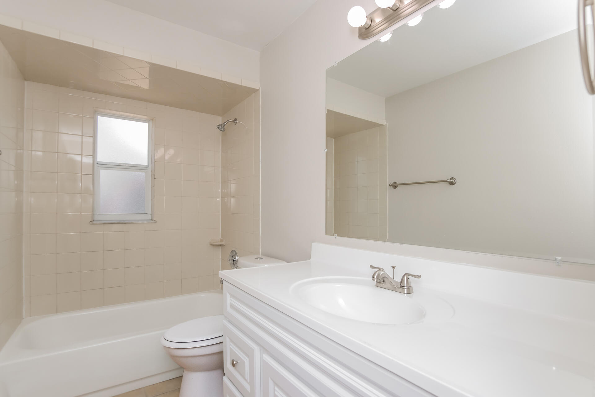 3386 Jay Tee Drive Melbourne, FL 32901 - Photo 13 of 16 a bathroom with a granite countertop sink a toilet and a bathtub
