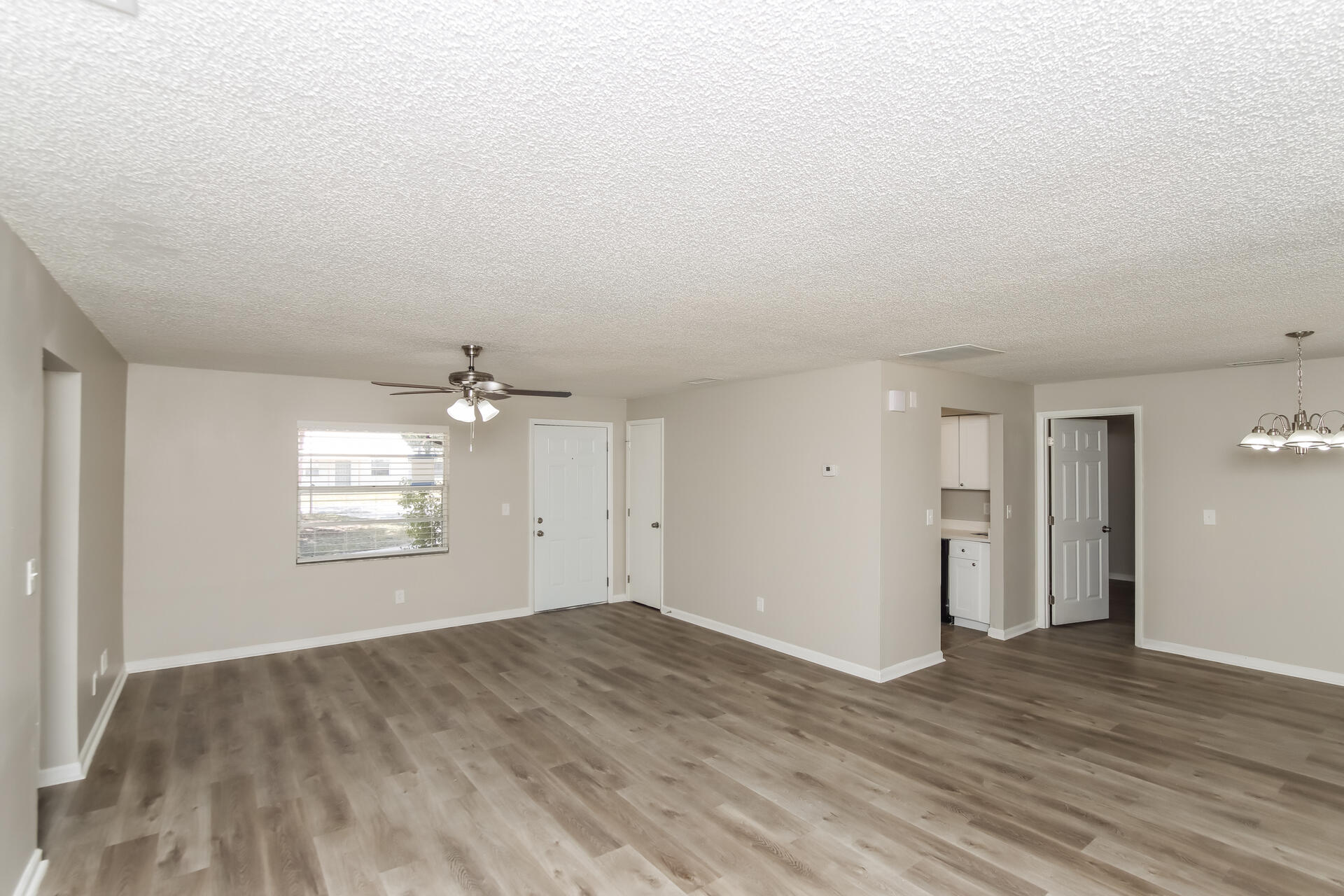3386 Jay Tee Drive Melbourne, FL 32901 - Photo 4 of 16 an empty room with wooden floor and windows