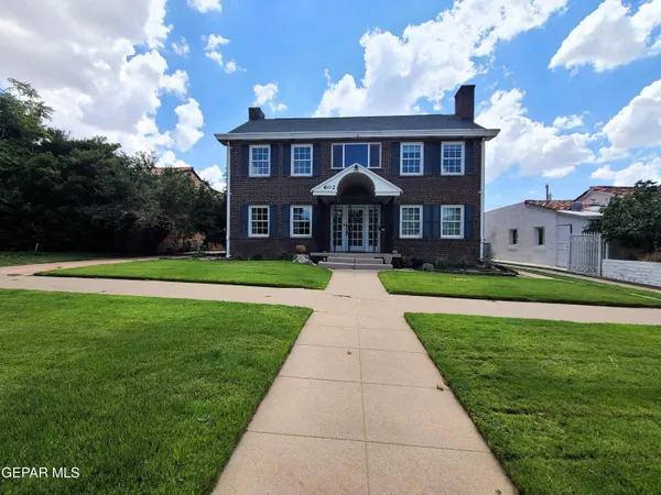 a front view of a house with swimming pool having outdoor seating