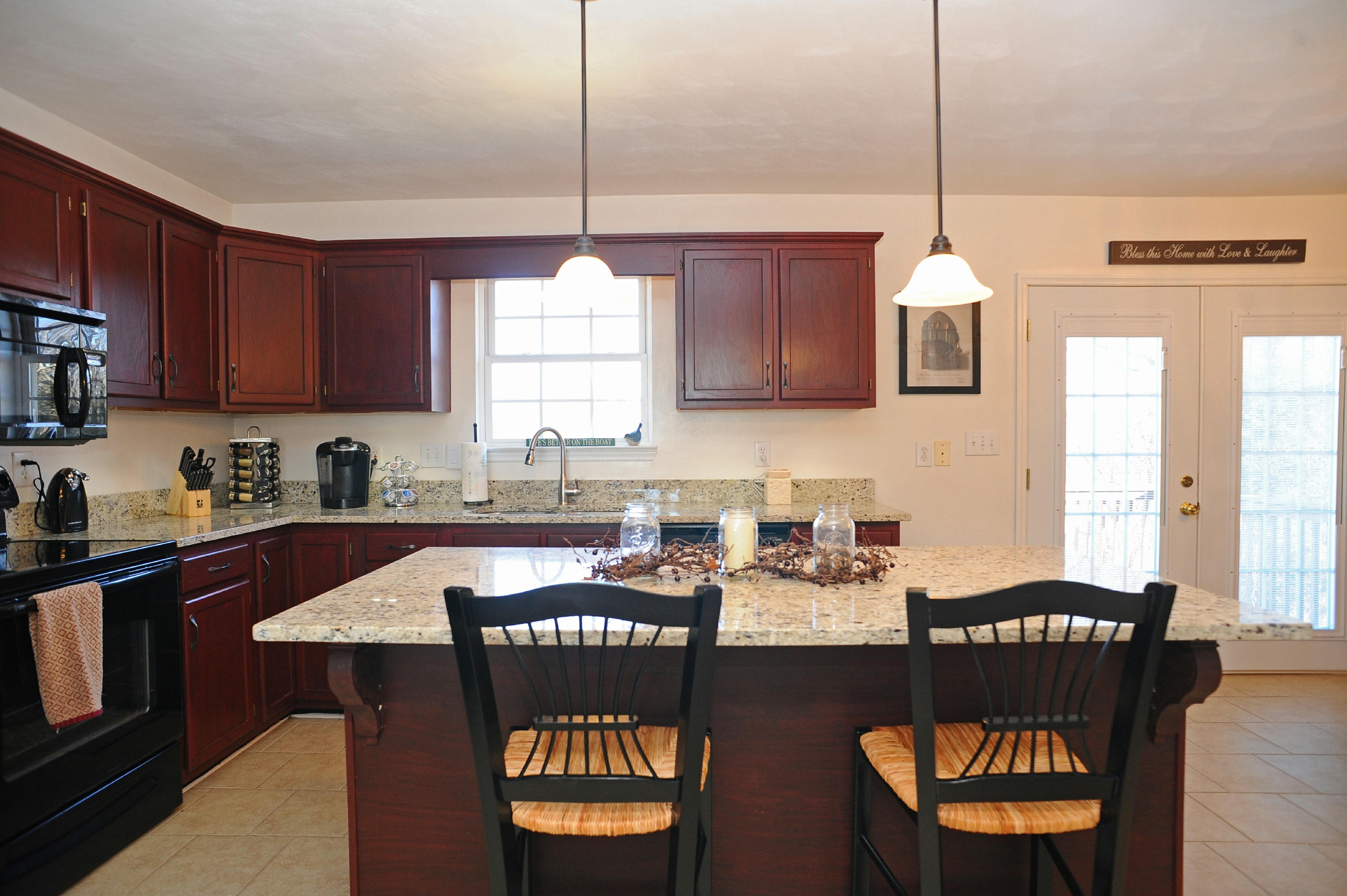 265 Northridge Road Hardy, VA 24101 - Photo 7 of 59 a kitchen with granite countertop a stove a sink a dining table and chairs with wooden floor