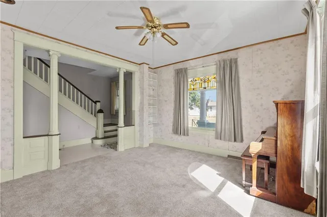 a view of an empty room with a cabinet and a window