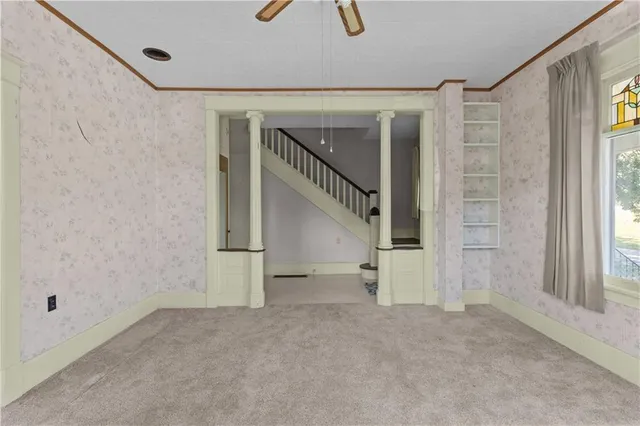a kitchen with a table chairs refrigerator and cabinets