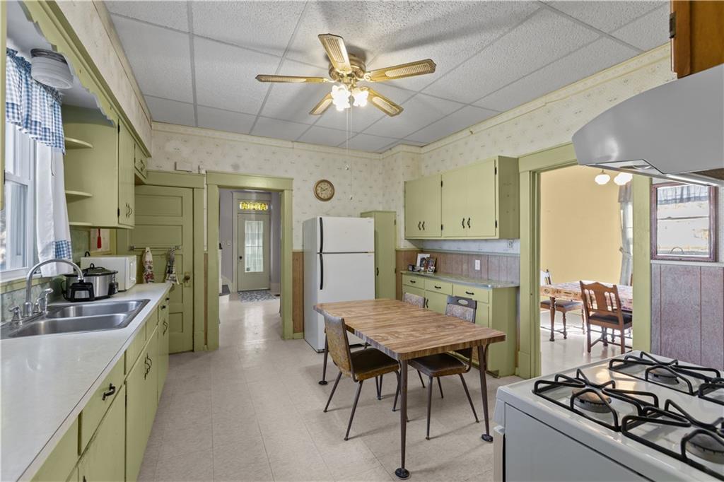 626 Sterner Street Confluence, PA 15424 - Photo 15 of 49 a kitchen with a table chairs stove and refrigerator