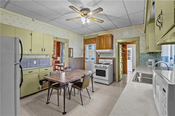 a stove top oven sitting inside of a kitchen
