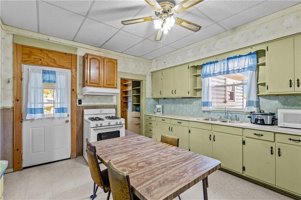 626 Sterner Street Confluence, PA 15424 - Photo 21 of 49 a kitchen with a table chairs refrigerator and cabinets
