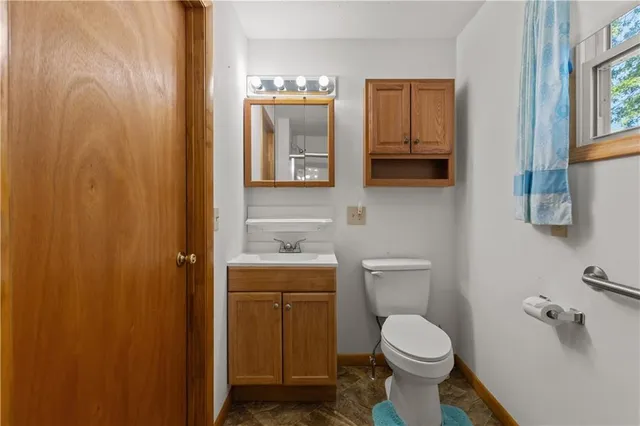 a bathroom with a toilet sink and mirror