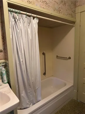 a view of a yard in front of a house with large tree