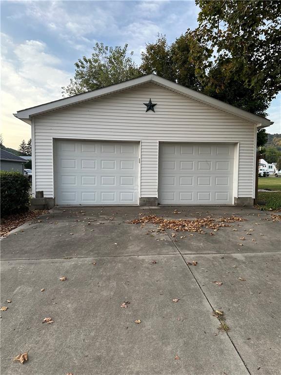 626 Sterner Street Confluence, PA 15424 - Photo 29 of 49 a front view of a house with a yard and garage