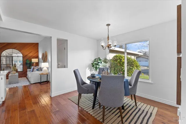 a view of a dining room with furniture window and wooden floor