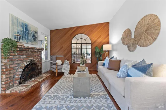 a living room with fireplace furniture and a fireplace