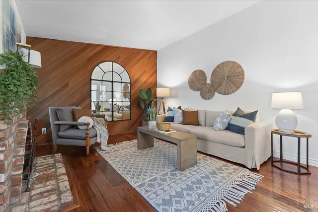 a living room with furniture a rug and a large window