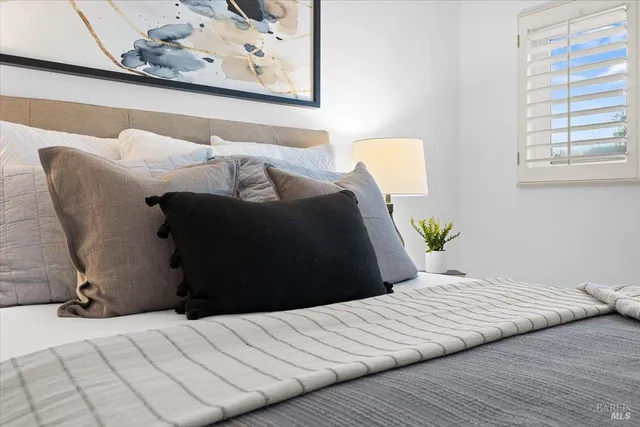 a bed sitting in a bedroom next to a window