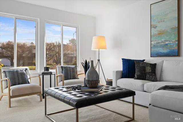a living room with furniture and a large window