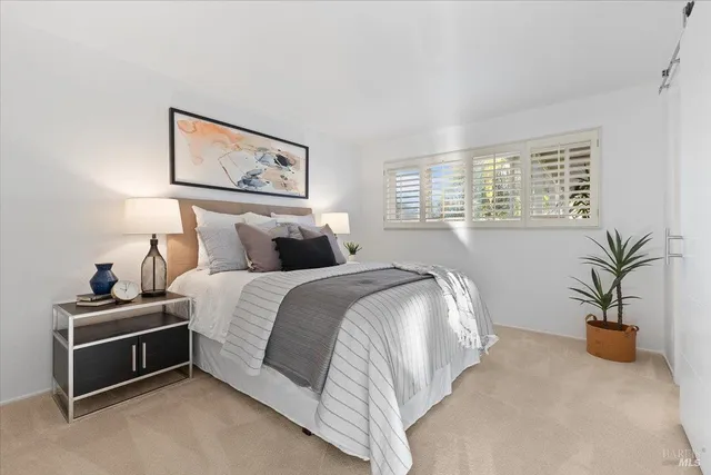 a bedroom with bed and a potted plant