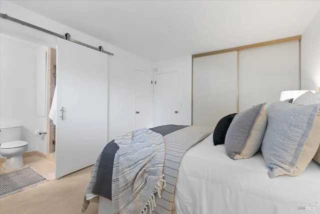 a bedroom with a bed and a shower