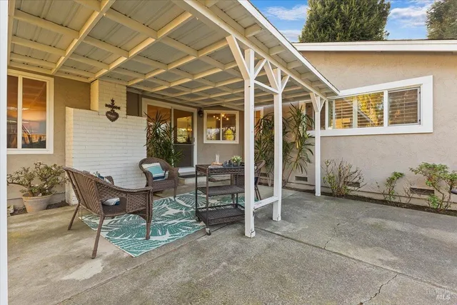 a view of a patio with table and chairs and potted plants