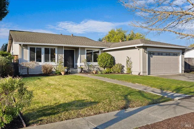a front view of house with yard and outdoor seating